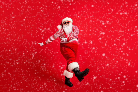 Full length body size view of his he nice handsome attractive cheerful Santa dancing having fun celebratory festal day x-mas occasion isolated bright vivid shine vibrant red color background