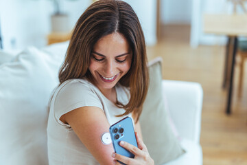 Woman Using Smartphone to Monitor Her Health with Sensor
