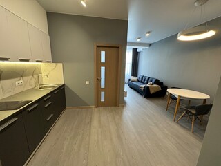 Obraz premium Modern open-plan kitchen and living room interior with minimalist design