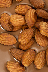 Almond nuts in melted milk chocolate macro