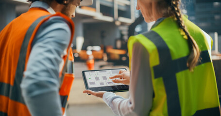 Specialists Using Tablet with Digital Technical Drawing Blueprints on Screen. Female Civil Engineer and an Architect Having a Conversation During an Outdoors Meeting at a Building Site Area