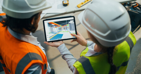 Construction and Site Managers Having a Meeting at a Construction Site. Specialists Using Tablet...