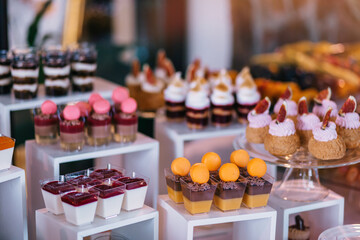 Festive table for newlyweds and guests. Dessert table for a wedding party
