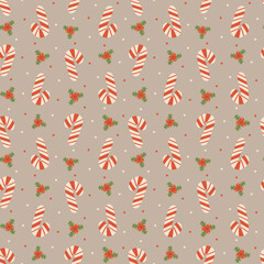 Christmas candy canes and holly berries vector seamless pattern design. For gift wrap, fabric design, scrapbook, wallpaper and more.