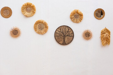 Wall decor featuring woven art pieces in natural tones across a light-colored background