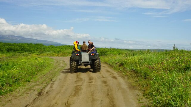 Happy Travelers Riding By Mud Guard In Rugged Terrain, Back View, Trip To Unique National Park