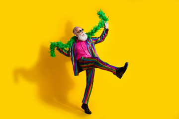Photo of positive cheerful retired man wear trendy striped bright clothes have fun isolated on...