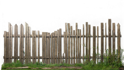 Fototapeta premium Weathered wooden fence with uneven heights and gaps, showing age and wear. Grass and weeds grow at the base transparent background