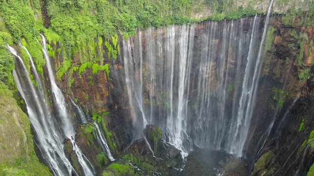 Drone move backward from Tumpak sewu waterfall in Java, Indonesia
