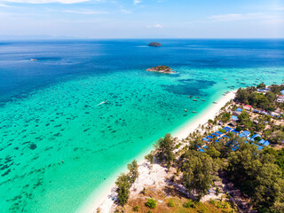 Beautiful tropical sea of Lipe Island with coral reef and traditional boat by the beach in summer...