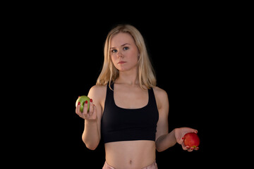 Confident Fit Girl Holding Green and Red Apples Against Black Background
