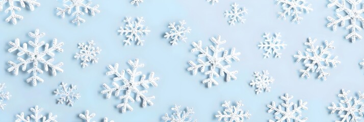 Silver snowflakes pattern on pastel blue background. Christmas and New Year holiday concept. Paper cut style. Winter design for greeting card, banner, wrapping paper, textile, print