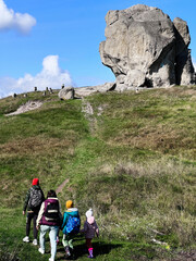 Family hike through scenic landscape with impressive rock formation