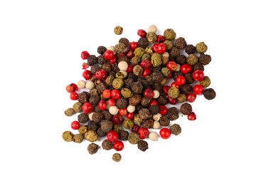 Mixture of dry round hot red pepper, black pepper, white pepper, green pepper, on the white background