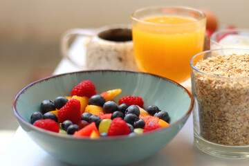 Assortment of various breakfast foods and drinks on the white table. Selective focus.