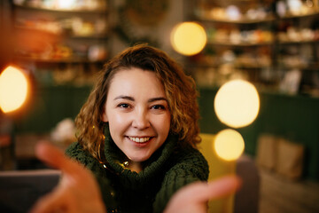 Festive holiday scene of a woman glowing with joy, surrounded by Christmas and New Year lights....