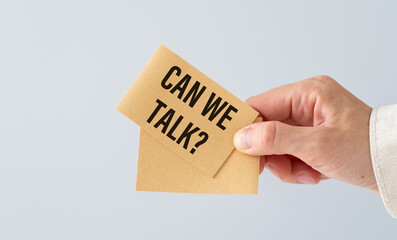 Can We Talk Text on Stickers In Hand on Light Background