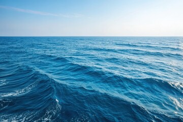 Fototapeta premium Vast Ocean Surface with Gentle Rolling Waves Under a Clear Sky