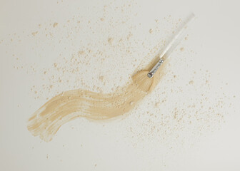 Spreading facial mask with brush on white.