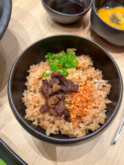 Delicious bowl of seasoned rice with beef toppings.