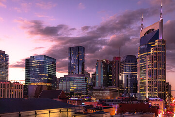 Fototapeta premium Downtown Nashville city skyline buildings view along the Cumberland River. Photo taken in Nashville Tennessee during blue hour evening