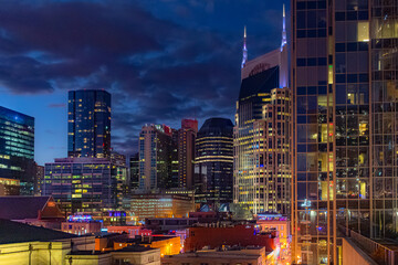 Downtown Nashville city skyline buildings view along the Cumberland River. Photo taken in Nashville Tennessee during blue hour evening