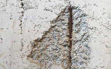 Old concrete wall with rust rebar steel rough surface.