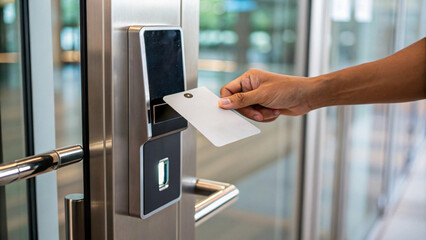 person using card to access secure entry system at modern building. sleek design and technology highlight security and convenience