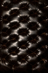 Elegant dark leather texture with intricate tufting and a glossy finish