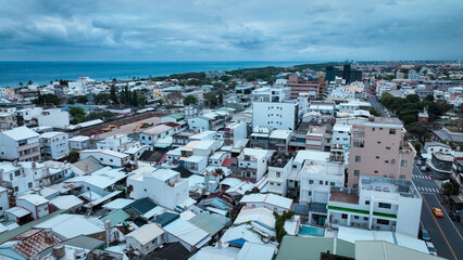 Aerial view of Taitung city showcasing coastal landscape and urban architecture on a cloudy day