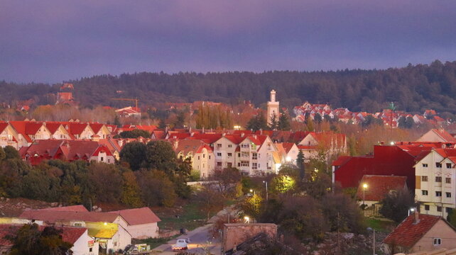Autumn in Morocco&rsquo;s Ifrane with Yellowed Maple Leaves, Red-Roofed Houses, Scenic Landscapes, Pedestrian Pathways, and Vibrant Seasonal Foliage in a Serene Countryside Setting  
