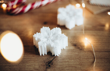 Christmas candle made of natural soy wax in the shape of a snowflake.