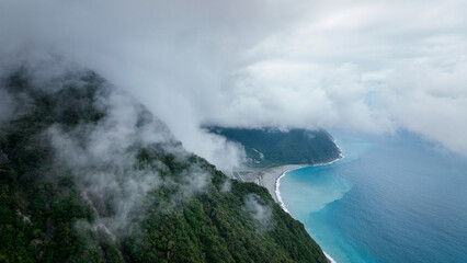 Aerial view of Taiwan coastline with clouds and mountains on a misty day