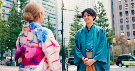 Fototapeta premium Japanese people, outdoor and fashion with traditional clothes, culture and kimono for heritage or style. Man, woman and city for pride, travel and outfit in street for dress, trip and clothing
