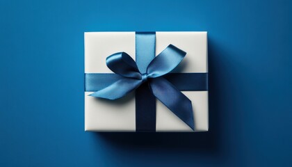 Beautifully wrapped gift box with blue ribbon on a blue background