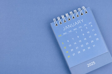 January 2025 calendar on blue background. Desk calendar for planning and organizing.