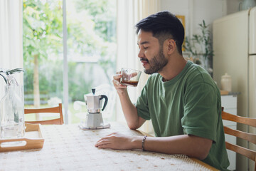 Man Enjoying Freshly Brewed Coffee in Bright, Cozy Vintage Kitchen
