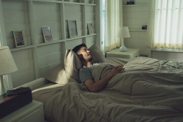 Obraz premium Man Resting Peacefully in Bed in Cozy, Softly Lit Bedroom