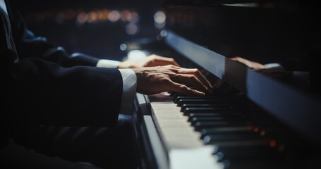 Close Up on Pianist Hands Playing a Mesmerizing Jazz Melody on a Black Grand Piano. Anonymous...