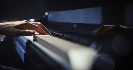 Close Up on Pianist Hands Playing a Mesmerizing Jazz Melody on a Black Grand Piano. Anonymous Artist is Focused on Creating Beautiful Instrumental Sonata as He Plays on Stage for the Audience © Gorodenkoff
