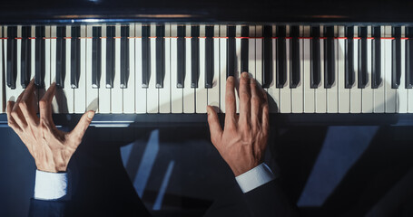 Close Up Top Down on Pianist Hands Playing a Mesmerizing Jazz Melody on a Grand Piano. Anonymous Artist is Focused on Creating Beautiful Instrumental Sonata as He Plays on Stage for the Audience © Gorodenkoff