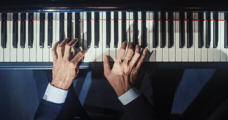 Top Down on Hands of a Talented Anonymous Pianist Making a Masterful Performance on a Grand Piano. Under Soft Stage Lights, His Fingers Move Across the Keys, Creating Beautiful Classical Music