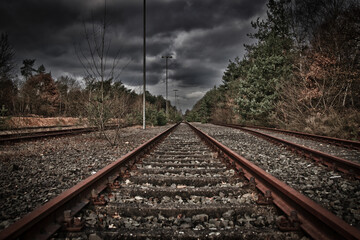 An old railway track disappears into the distance.