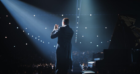 Pianist, Standing Proudly on Stage, Takes a Moment to Thank the Audience. He is Looking Straight at...