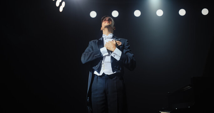 Pianist Standing Center Stage, Acknowledging the Cheerful Ovation With a Grateful Smile. He Puts Hands on Heart, Thanking the Audience for Their Appreciation and Support