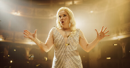 Talented Female Opera Singer With Blonde Hair and Outstretched Arms, Performing for Music Fans on a...