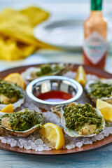 oysters rockafeller made with spinach, parsley, and garlic cream sauce