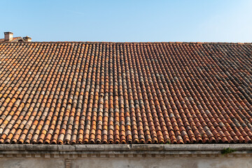 tiles of historic building, the large pitches of the sleeves of the and factories of the venice arsenal home to part of the biennial, imposing roofs with historic tiles. maintenance for infiltrations.