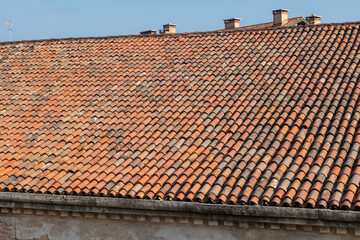 tiles of historic building, the large pitches of the sleeves of the and factories of the venice arsenal home to part of the biennial, imposing roofs with historic tiles. maintenance for infiltrations.