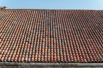 tiles of historic building, the large pitches of the sleeves of the and factories of the venice arsenal home to part of the biennial, imposing roofs with historic tiles. maintenance for infiltrations.